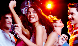 Dating | Photo of energetic girl dancing in the night club with her friends on background